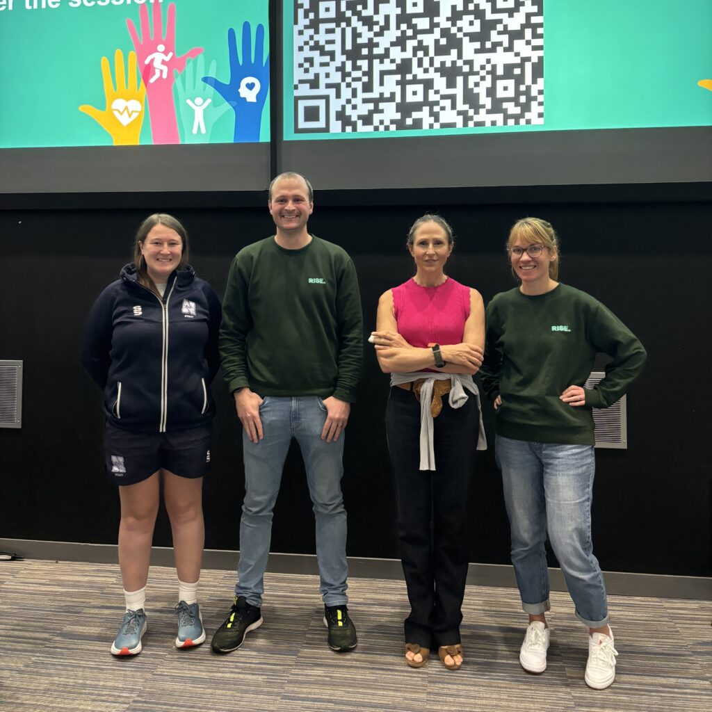 Staff standing in front of lecture screens