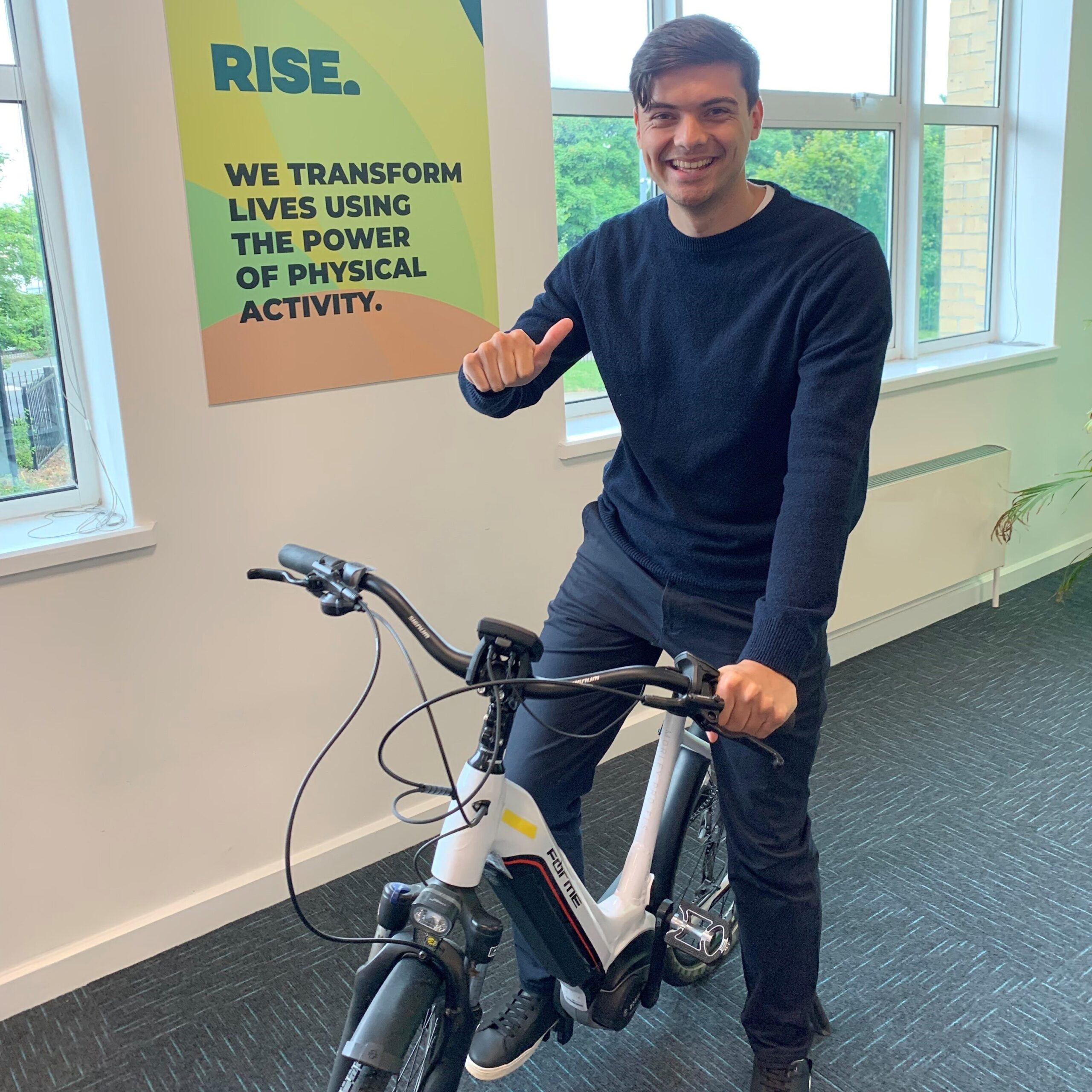 Rise team member on an electric bike