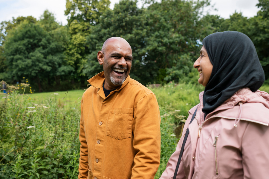 Two people walking in nature smiling