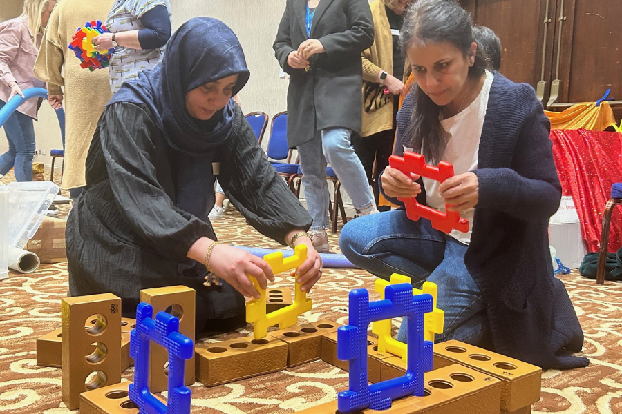 Two women using building blocks